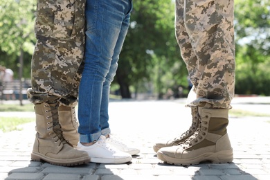Photo of Military couple with their son walking in park