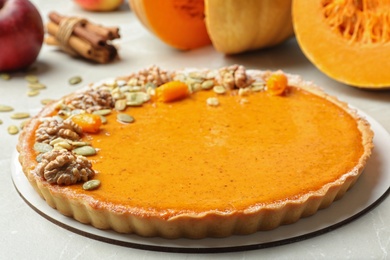 Delicious fresh homemade pumpkin pie on light grey marble table, closeup