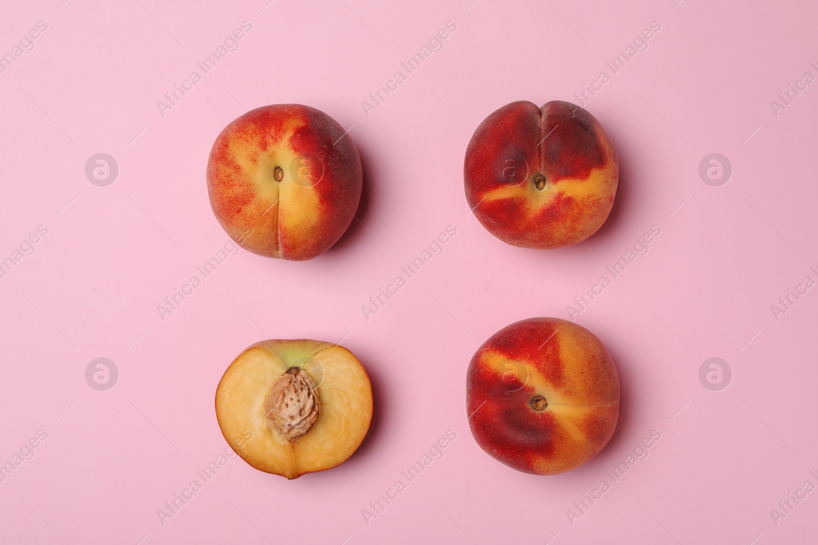 Photo of Sweet juicy peaches on pink background, top view