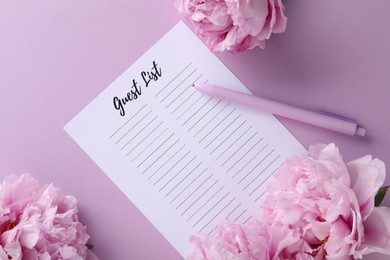 Guest list, pen and beautiful flowers on violet background, flat lay. Space for text