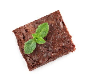 Photo of Delicious chocolate brownie with fresh mint leaves on white background, top view