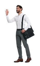 Photo of Handsome man with black bag waving to say hello while walking on white background