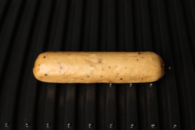 Photo of Delicious vegan sausage cooking on electric grill, closeup