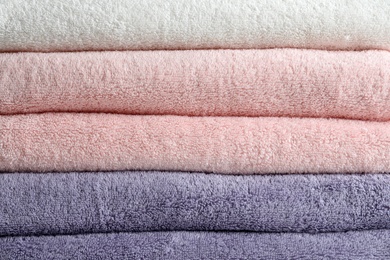 Photo of Stack of fresh soft towels as background