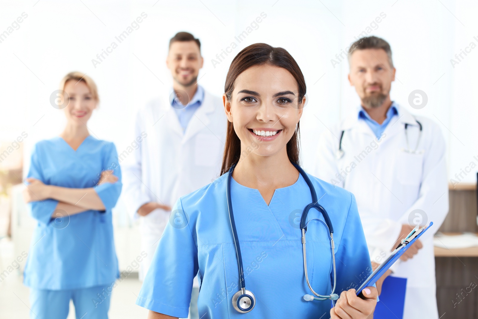 Photo of Medical assistant with colleagues in clinic. Health care service