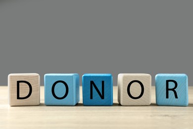 Photo of Word Donor made of cubes on wooden table