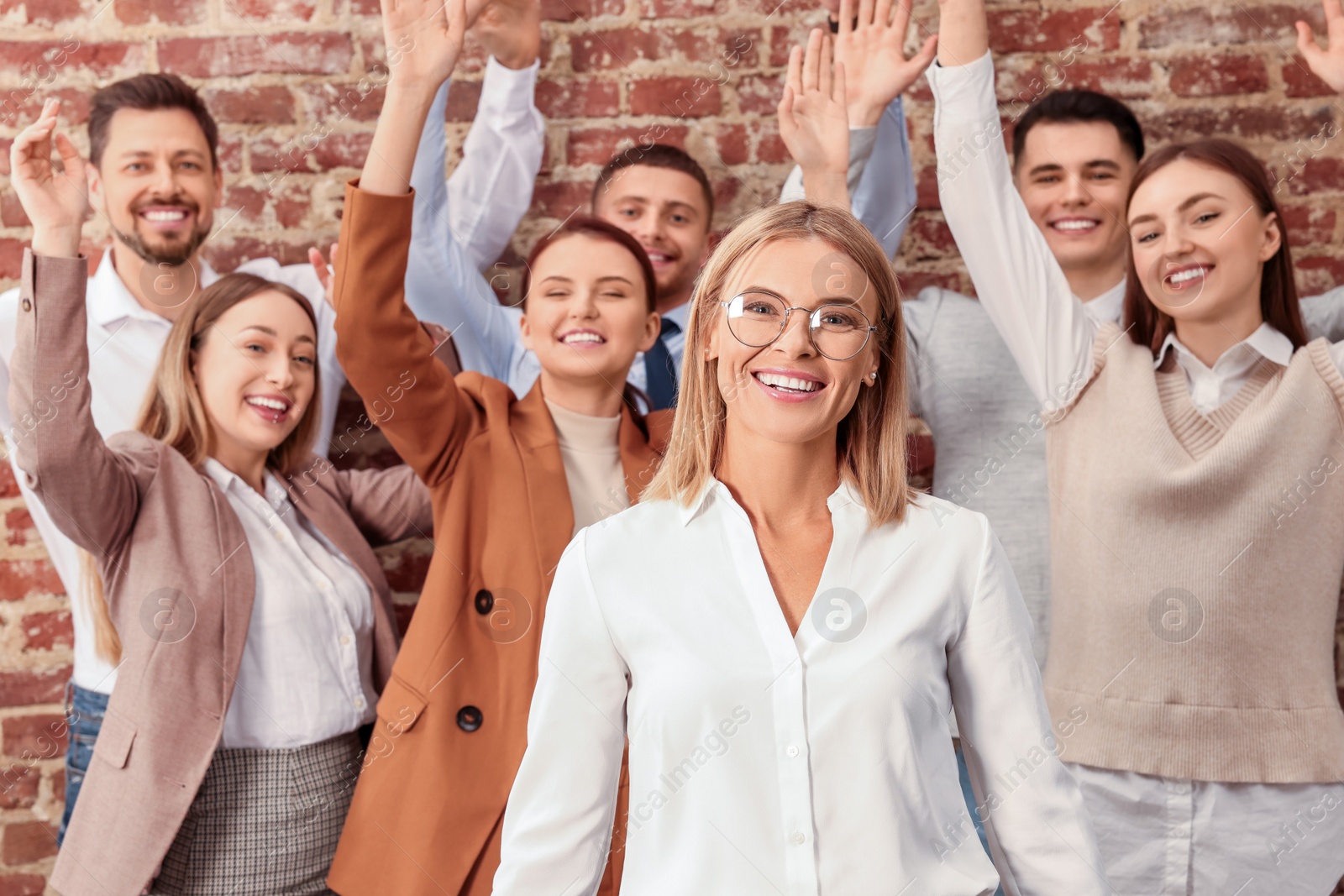 Photo of Businesswoman and her employees in office. Lady boss