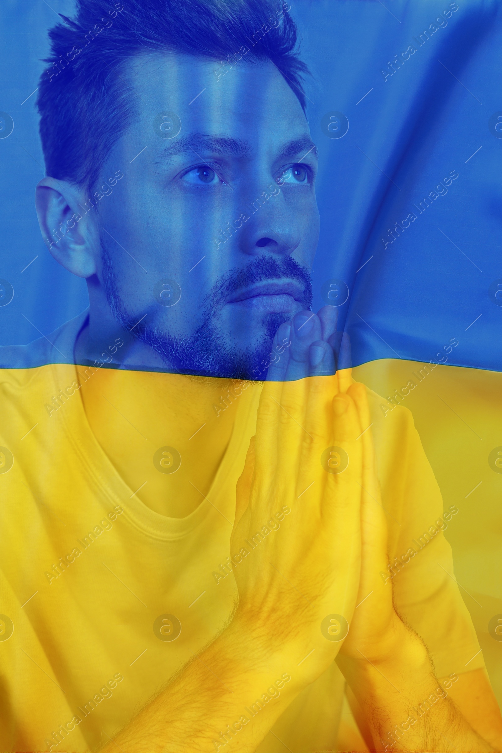 Image of Double exposure of national flag and man praying. Stop war in Ukraine