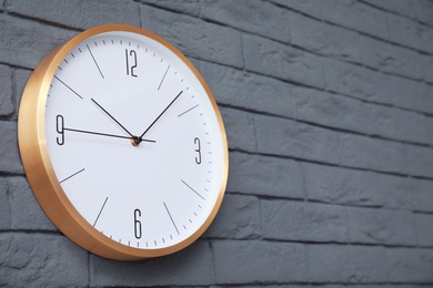 Modern clock on brick wall. Time concept