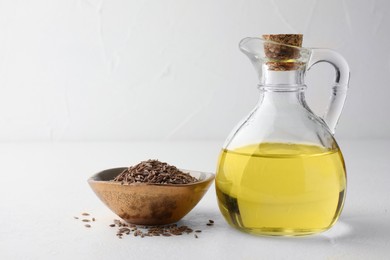 Photo of Caraway (Persian cumin) seeds in bowl and fresh oil on white table, space for text