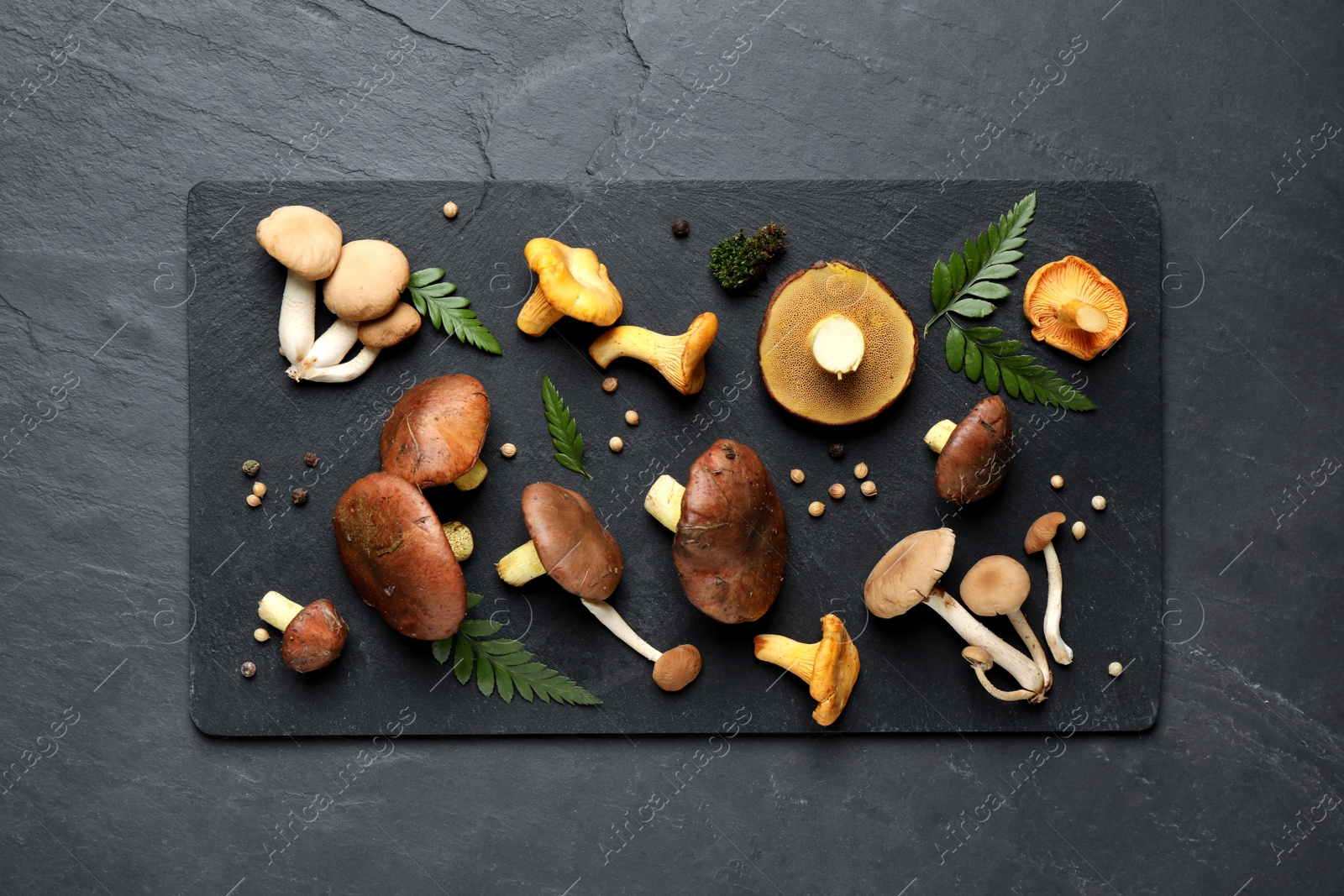 Photo of Flat lay composition with different mushrooms and pepper on grey background