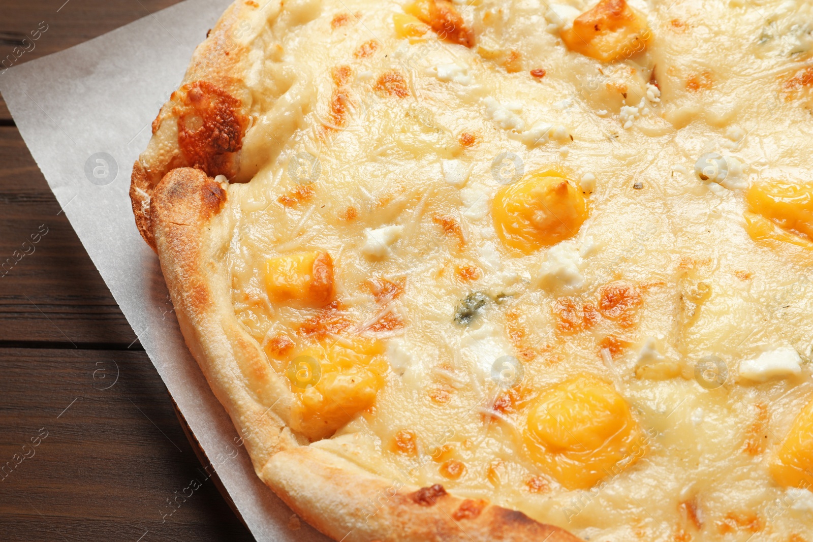 Photo of Hot cheese pizza Margherita on wooden table, closeup