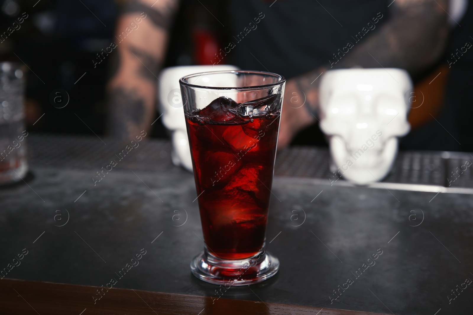 Photo of Glass of tasty cocktail on bar counter