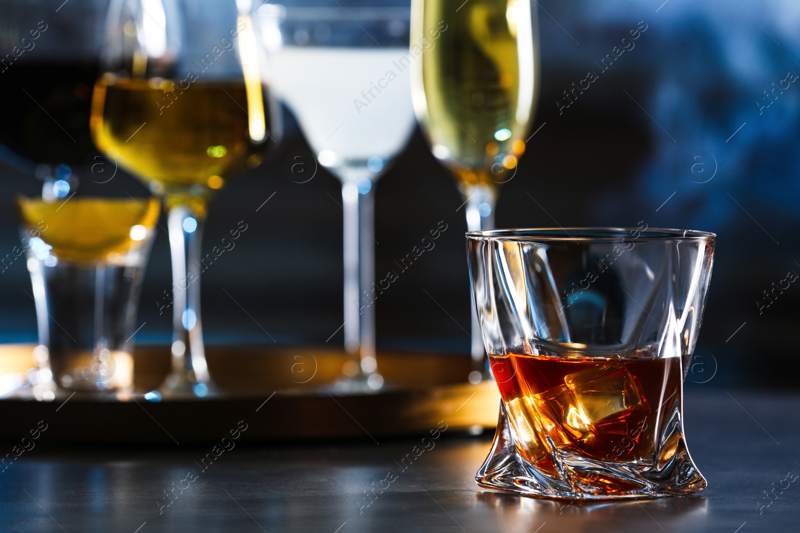 Photo of Glass of alcoholic drink on table, closeup. Space for text
