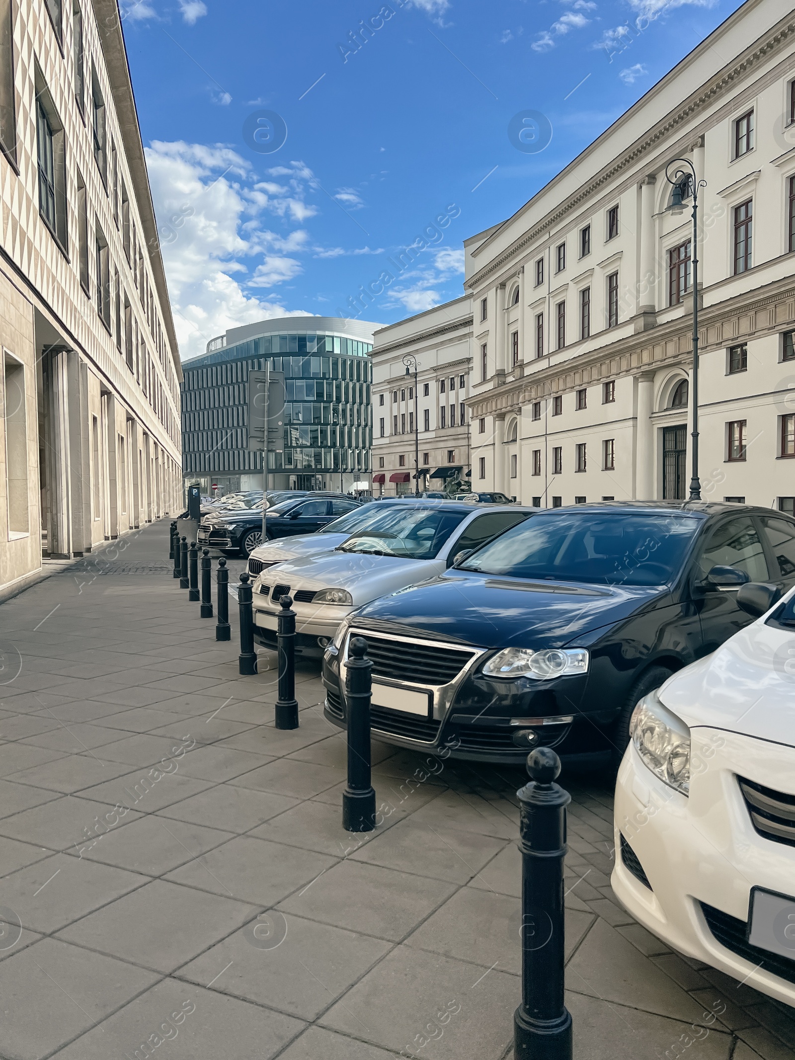 Photo of Different modern cars parked on city street