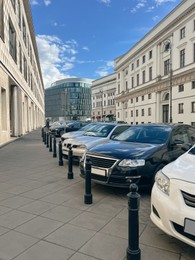 Photo of Different modern cars parked on city street