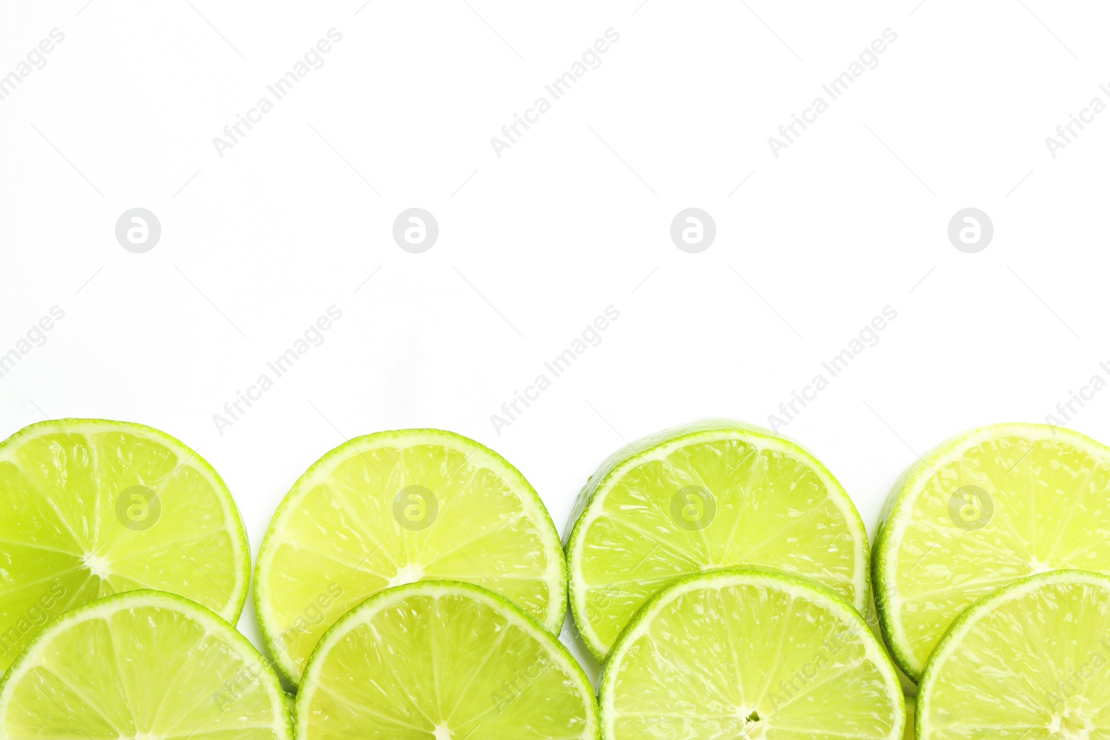 Photo of Fresh juicy lime slices on white background, flat lay. Space for text