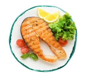 Plate with tasty salmon steak on white background