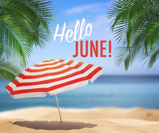 Image of Hello June. Open beach umbrella on sandy coast