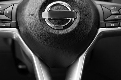 Photo of Safety airbag sign on steering wheel in car, closeup