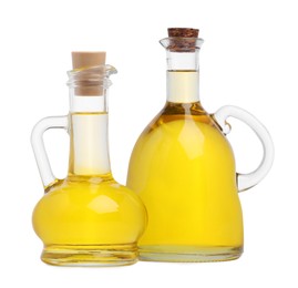 Photo of Glass jugs of cooking oil on white background