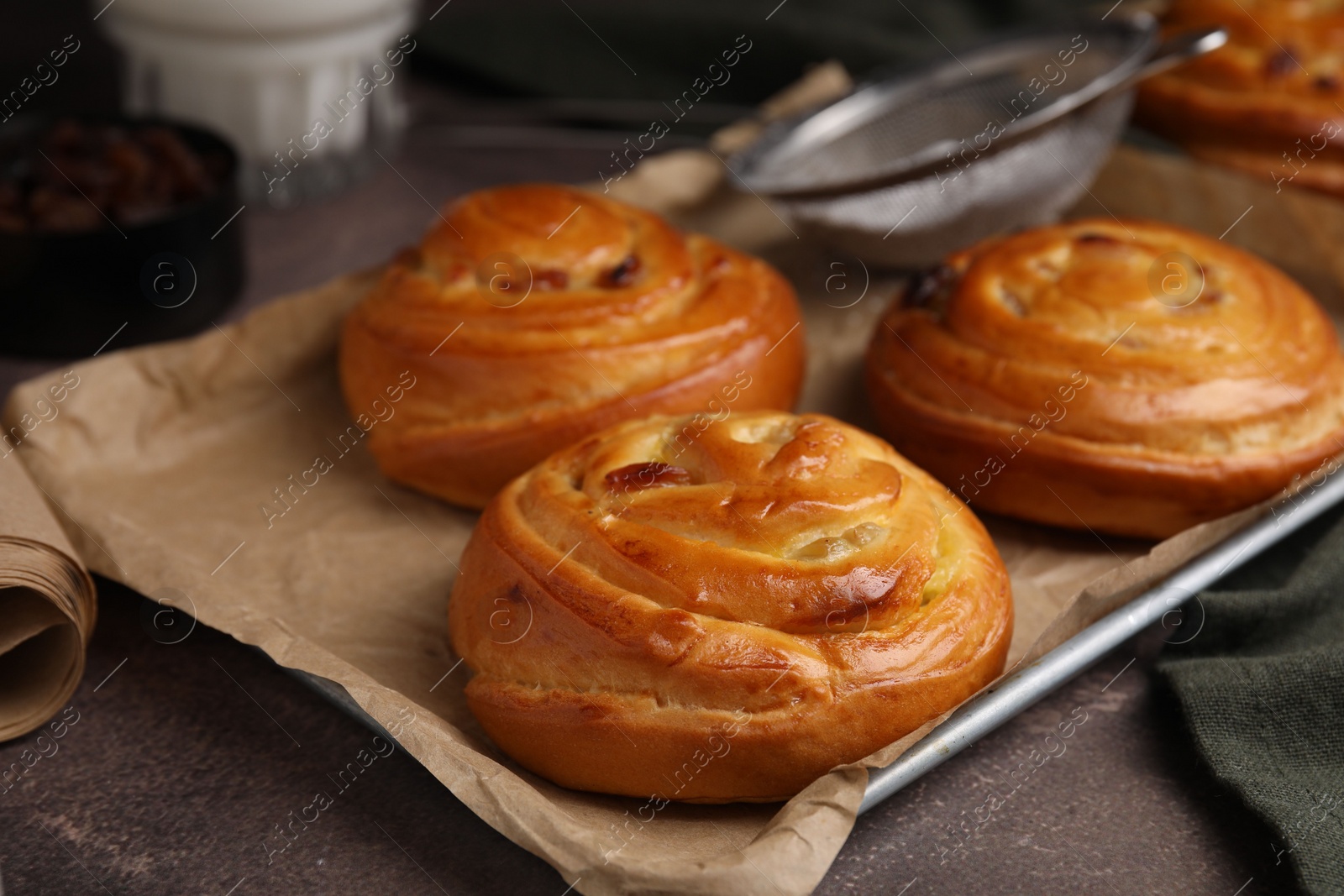 Photo of Delicious rolls on brown textured table, closeup. Sweet buns