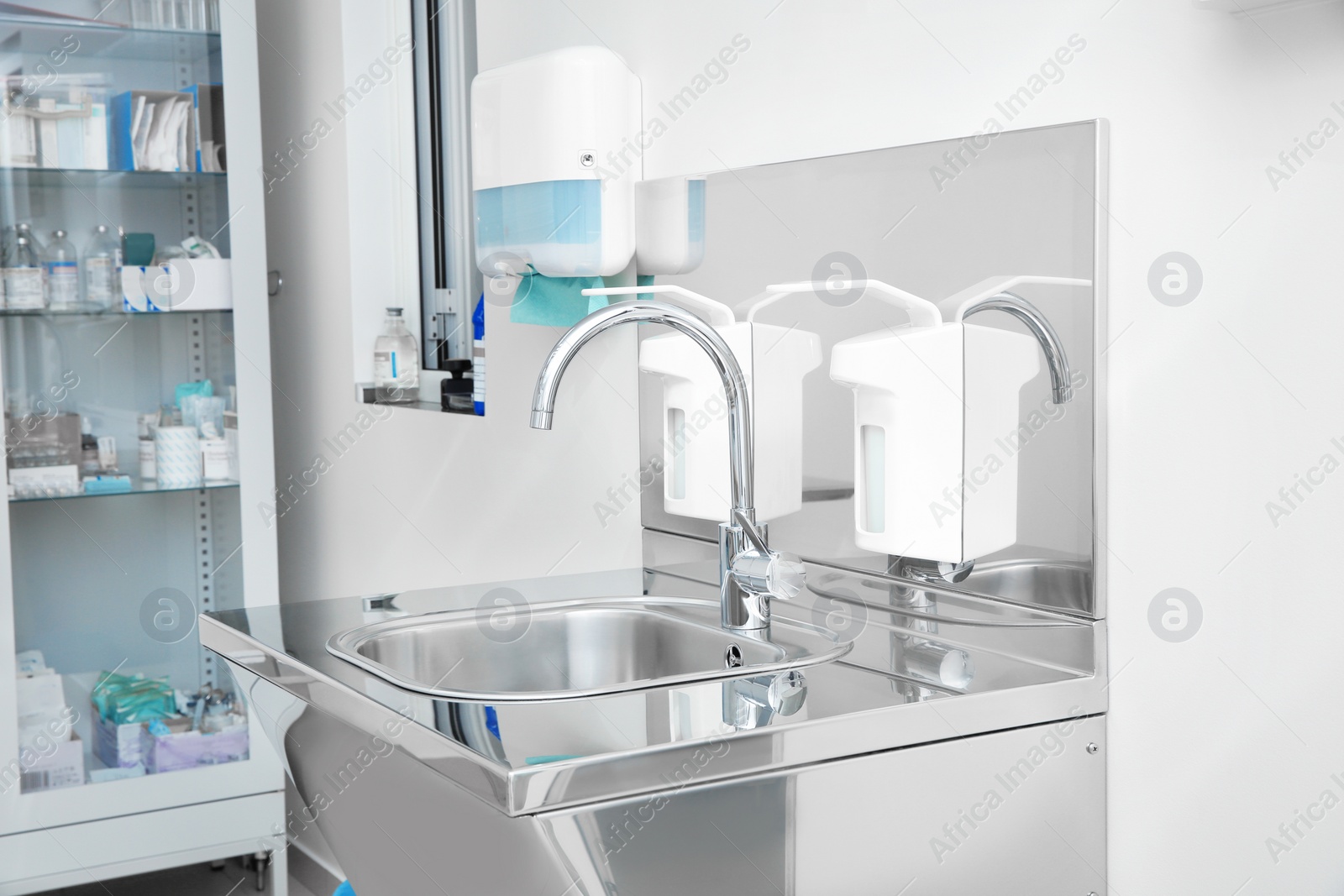 Photo of Sterile steel washbasin in modern surgery room