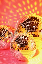 Photo of Many shiny disco balls on pink background