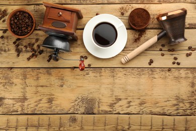 Photo of Flat lay composition with vintage manual coffee grinder and beans on wooden table, space for text