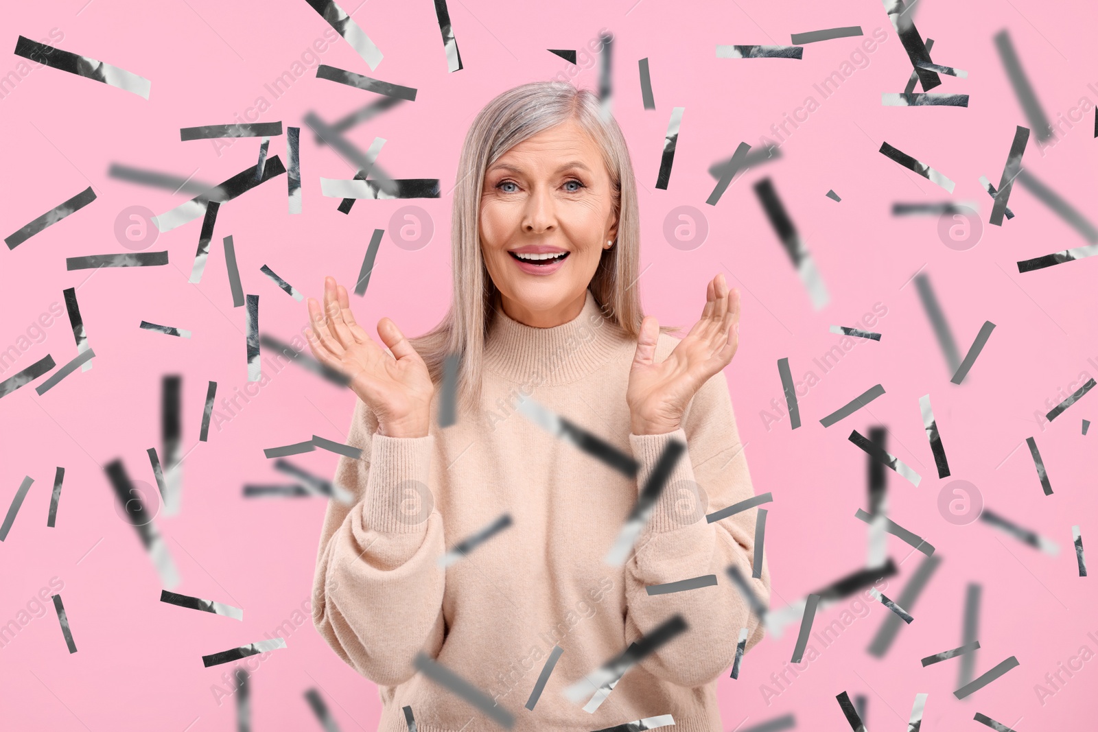 Image of Happy woman and flying confetti on pink background