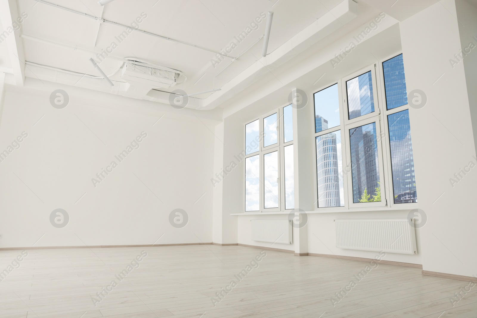 Photo of Modern office room with white walls and windows. Interior design