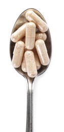 Photo of Gelatin capsules in spoon on white background, top view