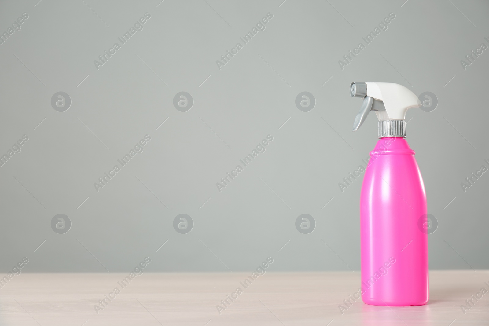 Photo of Bottle of cleaning product on light table. Space for text