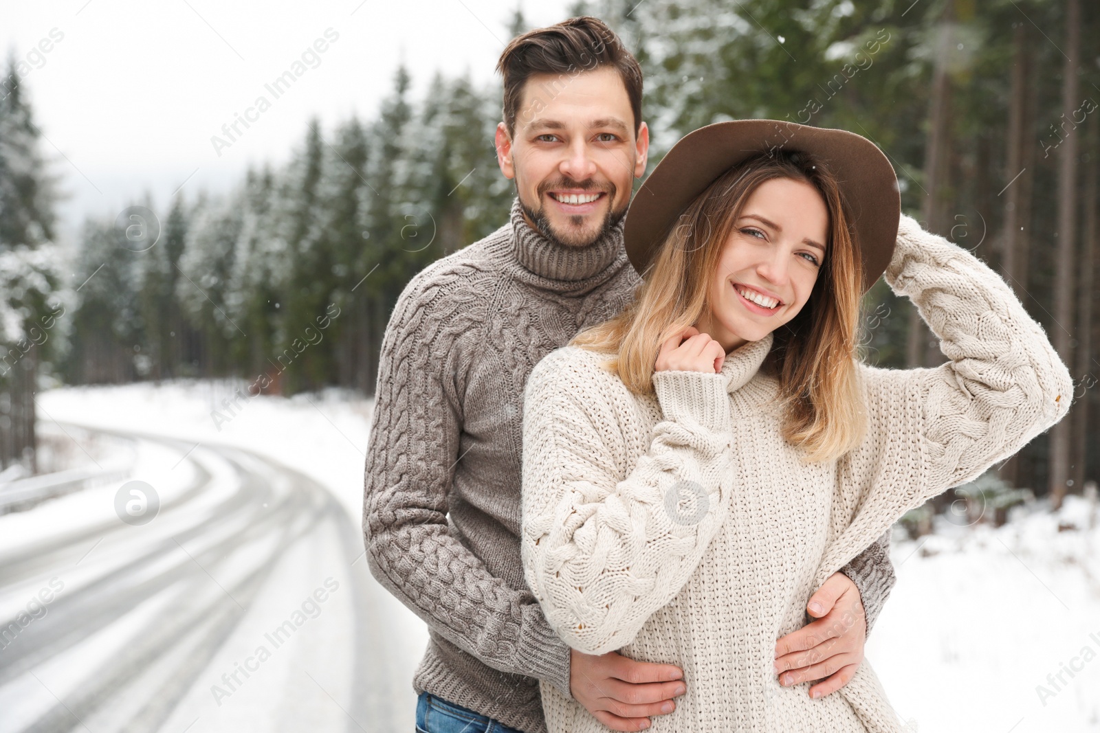 Photo of Cute couple outdoors on snowy day. Winter vacation