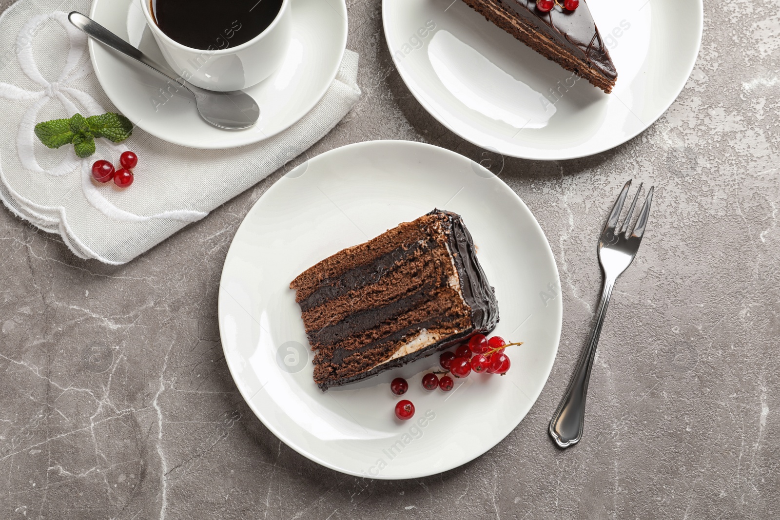 Photo of Slices of tasty chocolate cake and cup of coffee served on table, top view