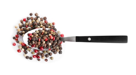 Photo of Spoon of mixed peppercorns isolated on white, top view
