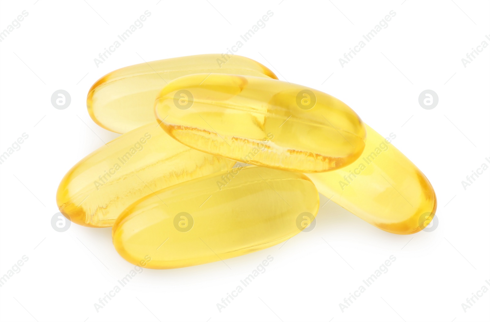 Photo of Many yellow vitamin capsules isolated on white