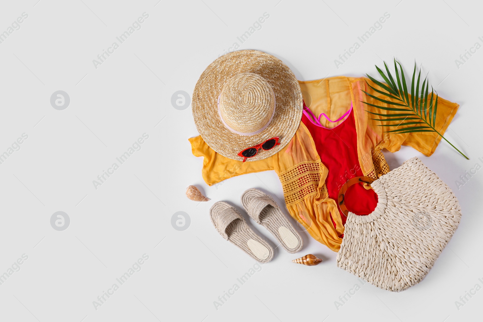 Photo of Flat lay composition with beach accessories on white background. Space for text