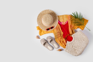 Flat lay composition with beach accessories on white background. Space for text