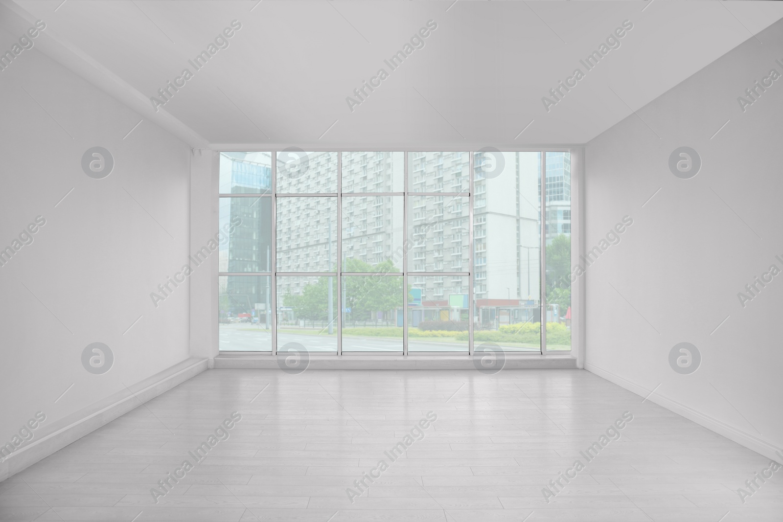 Photo of Empty room with large window and laminated floor