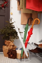 Photo of Colorful umbrellas, fir tree and gifts indoors