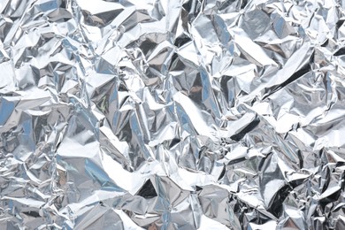 Crumpled silver foil as background, closeup view