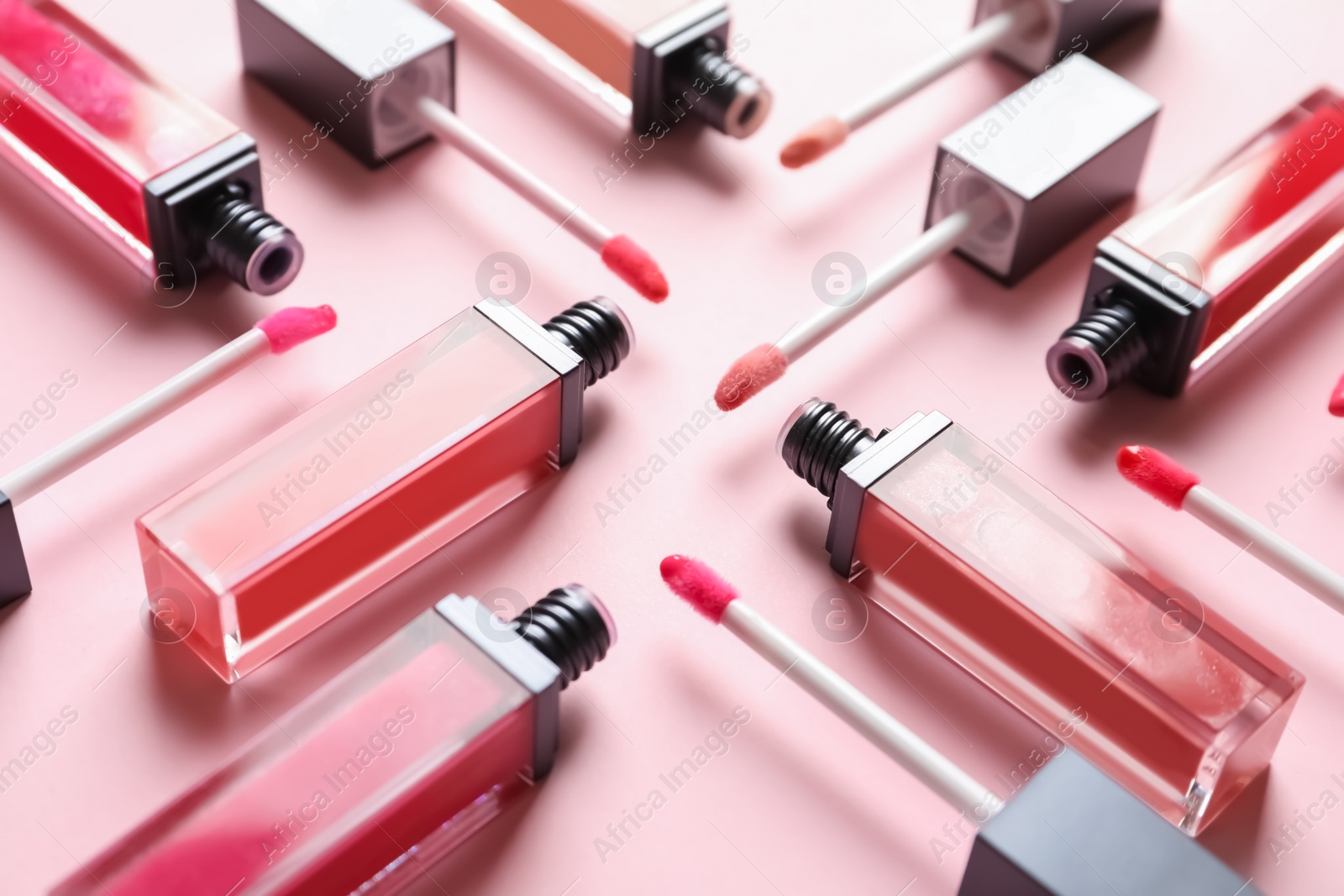 Photo of Composition of liquid lipsticks on color background