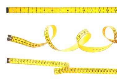 Image of Set of yellow measuring tapes on white background 