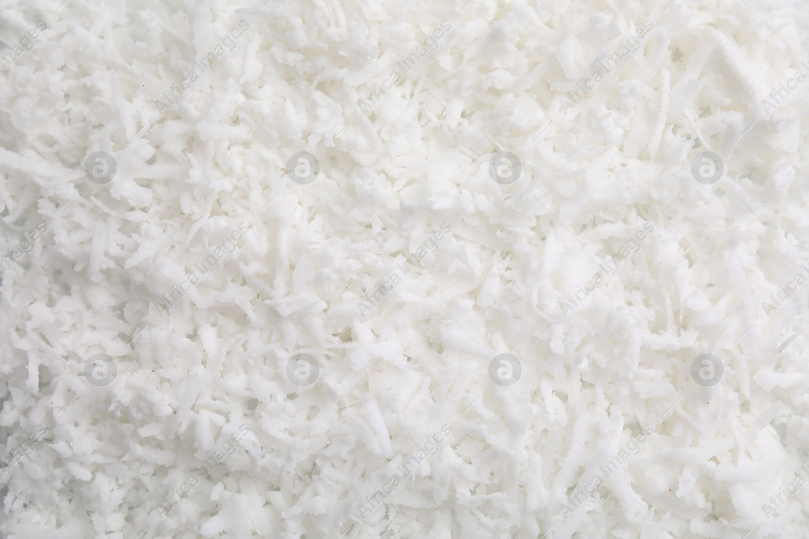 Photo of Fresh coconut flakes as background, top view