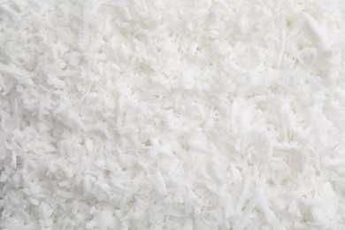 Photo of Fresh coconut flakes as background, top view