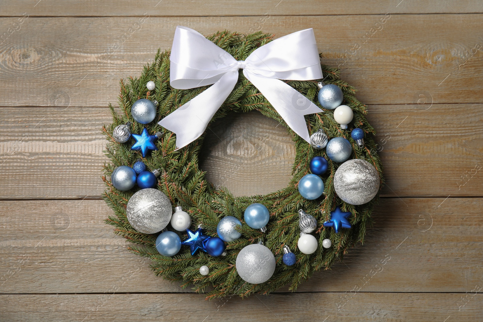 Photo of Beautiful Christmas wreath on wooden background, top view