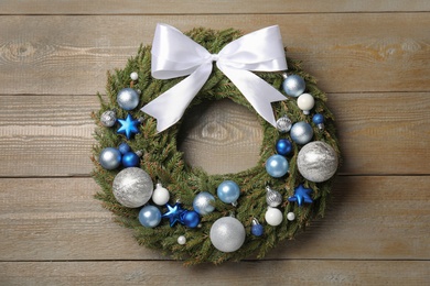 Beautiful Christmas wreath on wooden background, top view