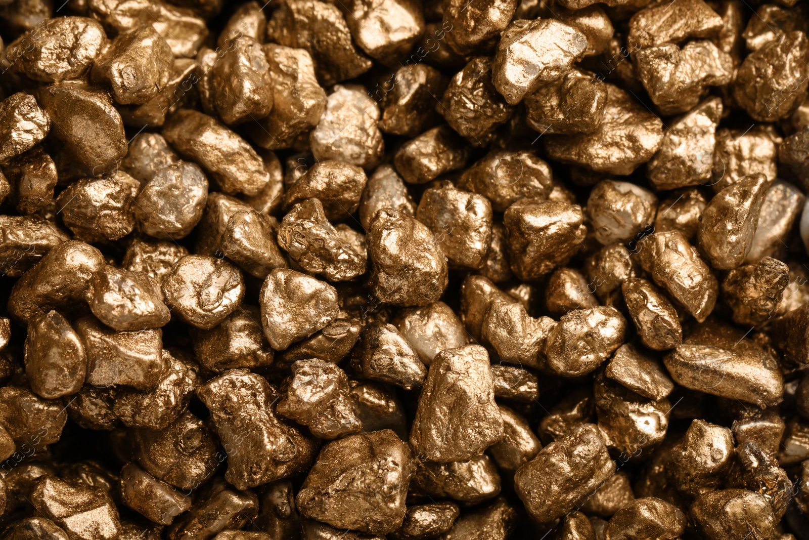 Photo of Pile of gold nuggets as background, closeup