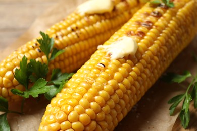 Photo of Tasty grilled corn with butter, closeup view